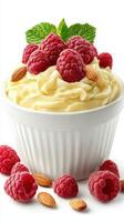 Delicious creamy dessert topped with fresh raspberries and almonds in a white bowl photo