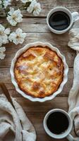 Freshly baked dessert paired with coffee and spring flowers on a rustic wooden table photo