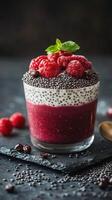 Delicious chia seed pudding topped with fresh raspberries and mint on a dark background photo