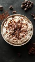 Indulging in velvety whipped cream topped with rich chocolate shavings and cocoa on a dark surface photo