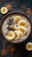 Delicious breakfast bowl with sliced bananas, chia seeds, and creamy oat base ready to energize your morning photo