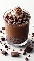 Decadent chocolate dessert topped with whipped cream and chocolate pieces in a glass cup photo