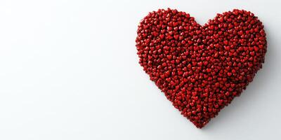 Heart made of tiny red hearts for celebration or decoration in bright background photo