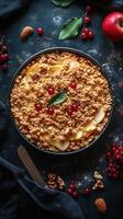 Freshly baked apple crumble with nuts and berries on a dark surface photo