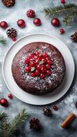 Festive chocolate cake adorned with cranberries and holiday decorations on a frosty table setting photo
