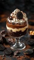 Indulgent chocolate dessert with cream and cookie topping served in a glass bowl photo