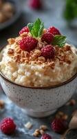 Delightful dessert bowl featuring creamy rice pudding topped with fresh raspberries and crunchy granola photo