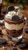 Delicious layered dessert featuring chocolate mousse and whipped cream topped with cookie pieces at a cozy cafe photo