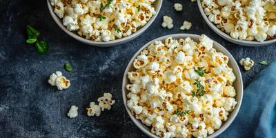 Bowls filled with fresh popcorn on a dark background perfect for movie night gatherings photo