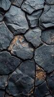 Dark volcanic rock formation showcases natural textures and colors in a rugged landscape photo