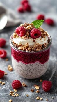 Delicious chia seed pudding layered with raspberry sauce and granola, perfect for a healthy dessert or snack option photo