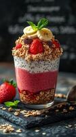 Delicious layered dessert with fresh fruit, yogurt, and granola served in a glass with mint garnish photo