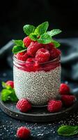 Delicious raspberry chia pudding served in a glass jar garnished with fresh mint leaves photo