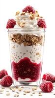 Delicious layered dessert with raspberries, yogurt, and granola in a clear glass container photo