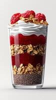 Delicious layered dessert featuring raspberries, yogurt, and crunchy granola in a clear glass cup photo