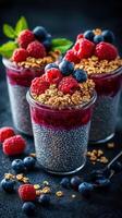Delicious chia seed pudding topped with fresh berries and granola served in elegant jars photo