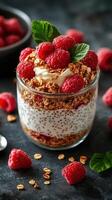 Delicious raspberry parfait with granola and yogurt served in a glass jar on a dark background photo