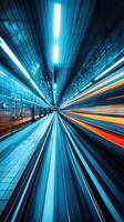 Motion blur in an urban subway station captures the speed of a departing train in vibrant blue and orange tones photo