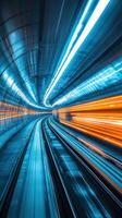 Dynamic view of a high-speed subway tunnel illuminated with blue and orange lights during rapid transit photo
