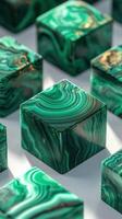 Unique green and black patterned crystal cubes arranged on a reflective surface reflecting sunlight in a serene setting photo