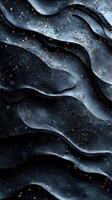 Textured black surface with golden specks highlights intricate patterns and depth under soft lighting photo