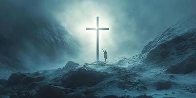 Light radiates from a cross as a figure reaches out in a serene, snowy mountain landscape during twilight photo