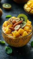 Vibrant mango and kiwi smoothie bowl topped with nuts and seeds photo