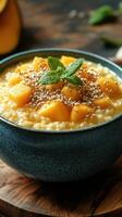 Creamy mango dessert with sesame seeds in a blue bowl served on a wooden table photo