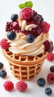 Decadent soft serve ice cream topped with fresh berries and fruity sauce in a waffle cone photo