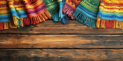 Colorful woven textiles draped over rustic wooden surface in a vibrant display of craftsmanship photo