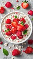 Fresh strawberries and raspberries adorn creamy oatmeal in a rustic setting photo