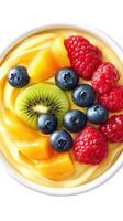 Fresh fruit bowl topped with kiwi, mango, blueberries, and raspberries served in a creamy yogurt base photo
