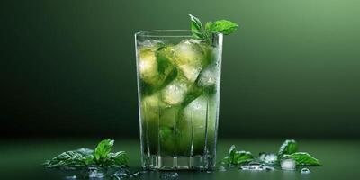 Refreshing mint mojito with ice served in a tall glass on a green background in a bright setting photo