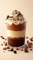 Delicious chocolate and vanilla dessert topped with whipped cream and chocolate shavings in a glass jar photo