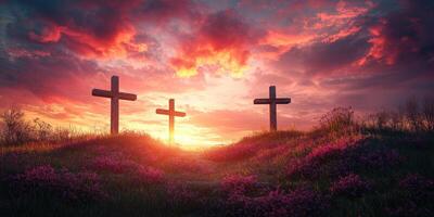 Three wooden crosses stand against a vibrant sunset sky filled with clouds over a flower-covered hillside photo