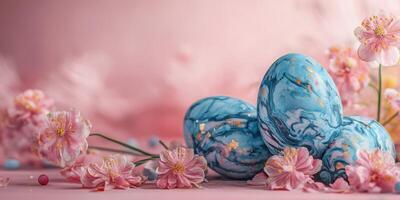 Colorful marble Easter eggs arranged with pink blossoms on a soft background during spring celebration photo