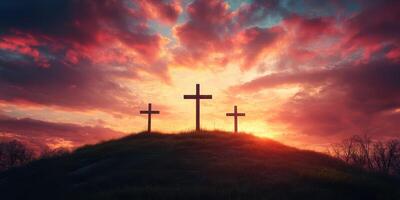 Sunset over three crosses on a hilltop with vibrant clouds creating a serene atmosphere photo