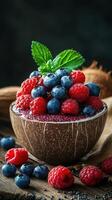 Delicious berry bowl with fresh raspberries and blueberries served in a coconut shell photo