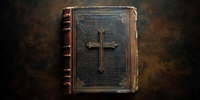 Beautifully crafted leather-bound book featuring an embossed cross on the cover resting on a dark textured surface photo