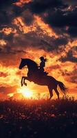 Sunset silhouette of a rider on a horse against vibrant orange and purple skies photo