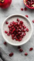Delicious chia pudding topped with vibrant pomegranate seeds in a rustic bowl photo