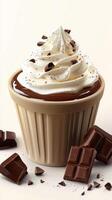 Delicious whipped cream topped chocolate dessert in a cup with chocolate pieces photo