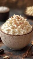 Delicious whipped cream topping in a rustic bowl with cocoa powder on top photo