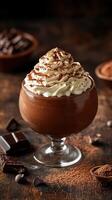 Indulgent chocolate mousse with whipped cream and cocoa topping in a cozy dessert setting photo