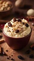 Creamy rice pudding with spices and raisins served in a rustic bowl garnished with chocolate shavings photo
