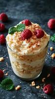 Delicious dessert served in a glass with raspberries and mint on a dark background photo
