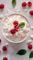 Delicious creamy dessert topped with fresh raspberries and coconut on a rustic background photo