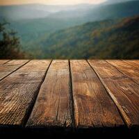 A wooden table with a view of mountains photo