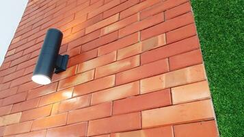 Outdoor lighting displays on exposed red bricks with close-up. photo