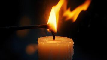 A close-up captures the intimate moment of a candle being lit, the flame dancing with a warm, golden light against the dark background, symbolizing hope and tranquility photo